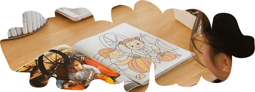 A child coloring a personalized book made from family photos